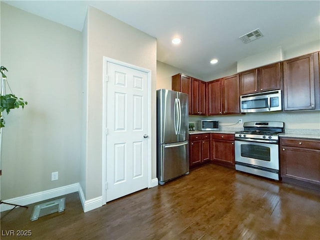 kitchen featuring dark wood finished floors, light countertops, visible vents, appliances with stainless steel finishes, and baseboards