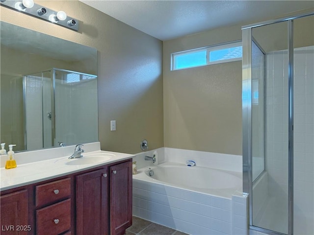 full bathroom with a stall shower, tile patterned floors, a bath, and vanity