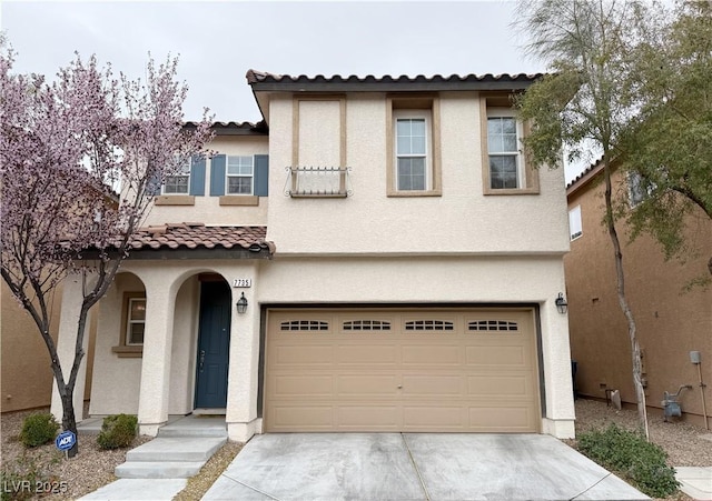 view of front of home featuring a garage, concrete driveway, a tiled roof, and stucco siding