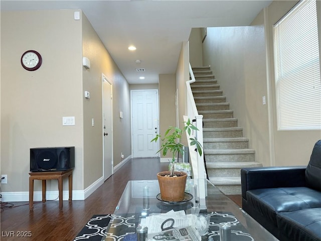 living area with visible vents, baseboards, wood finished floors, stairs, and recessed lighting