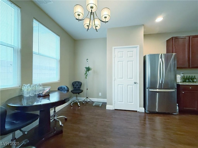 dining space featuring dark wood-style floors, recessed lighting, baseboards, and a notable chandelier