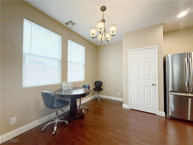 home office featuring an inviting chandelier, dark wood finished floors, visible vents, and baseboards