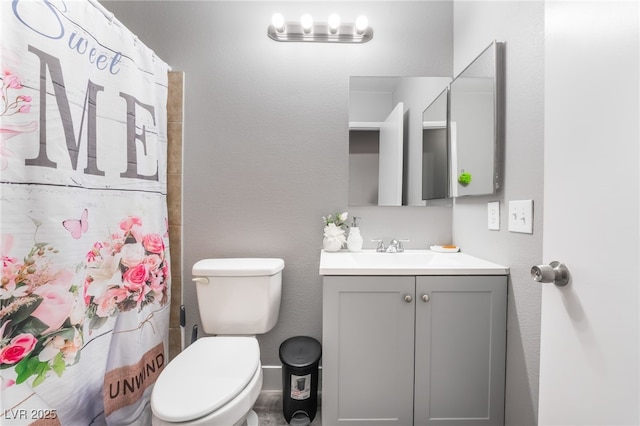 bathroom with a shower with shower curtain, vanity, and toilet