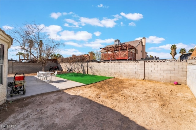 view of yard with a patio area and a fenced backyard