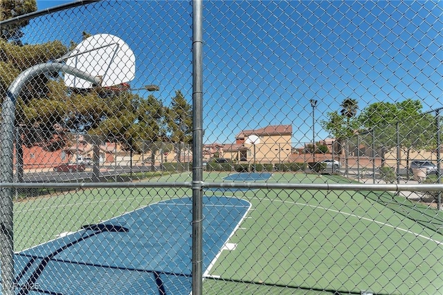 view of sport court featuring community basketball court and fence