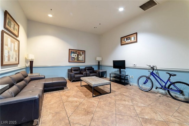 living area with light tile patterned floors, baseboards, visible vents, and recessed lighting