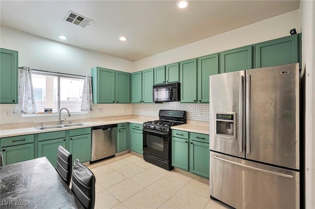 kitchen featuring light tile patterned floors, tasteful backsplash, visible vents, black appliances, and a sink