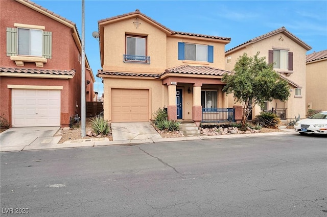 mediterranean / spanish-style home with a garage, driveway, covered porch, and stucco siding