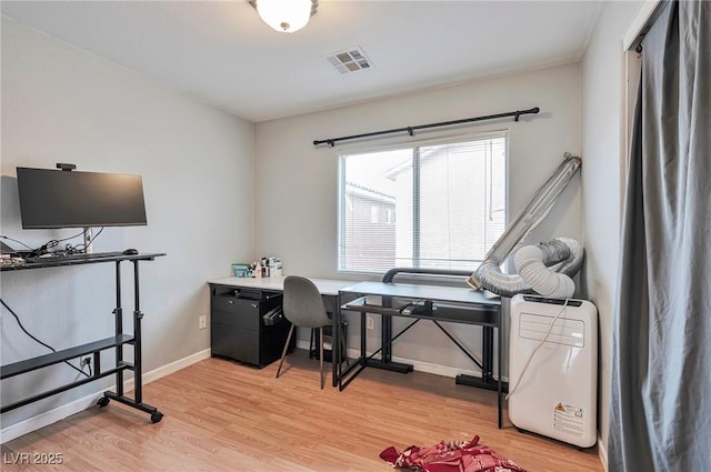 office space featuring light wood-style floors, visible vents, and baseboards