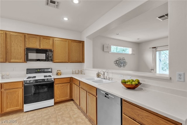 kitchen with visible vents, black microwave, range with gas stovetop, stainless steel dishwasher, and a sink