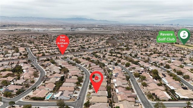 drone / aerial view featuring a residential view and a mountain view