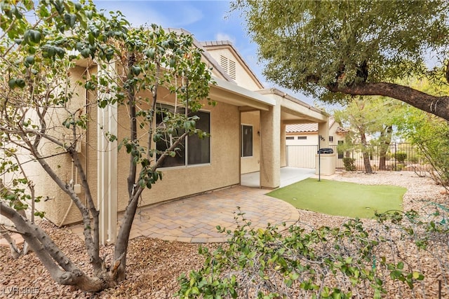 back of property with a patio area, fence, and stucco siding