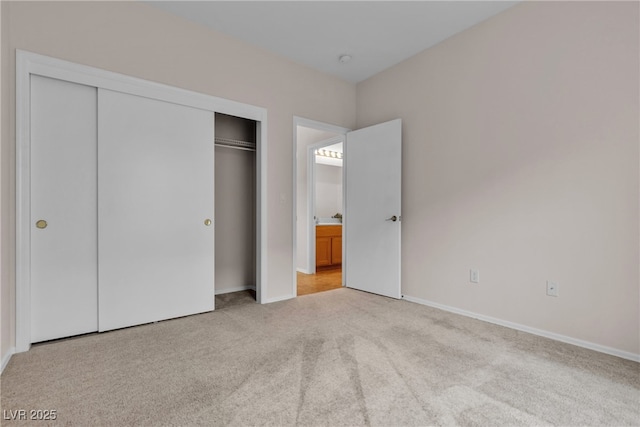 unfurnished bedroom featuring a closet, baseboards, and carpet floors