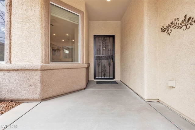 doorway to property with stucco siding