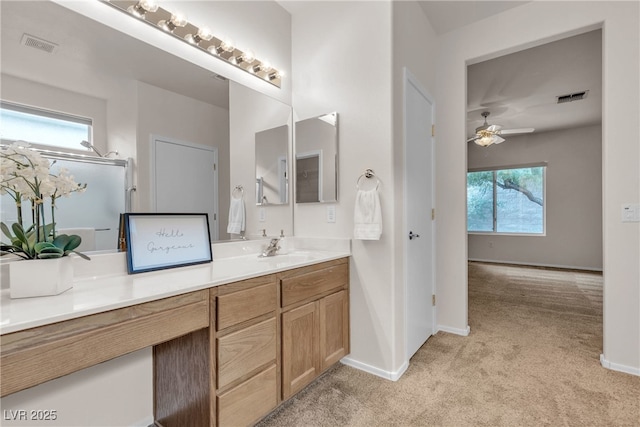 bathroom with vanity, baseboards, visible vents, and ceiling fan