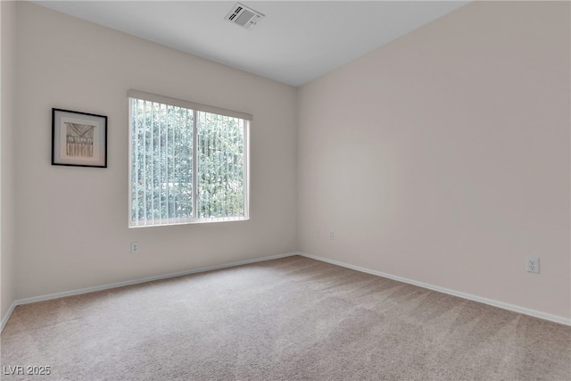 carpeted empty room featuring visible vents and baseboards