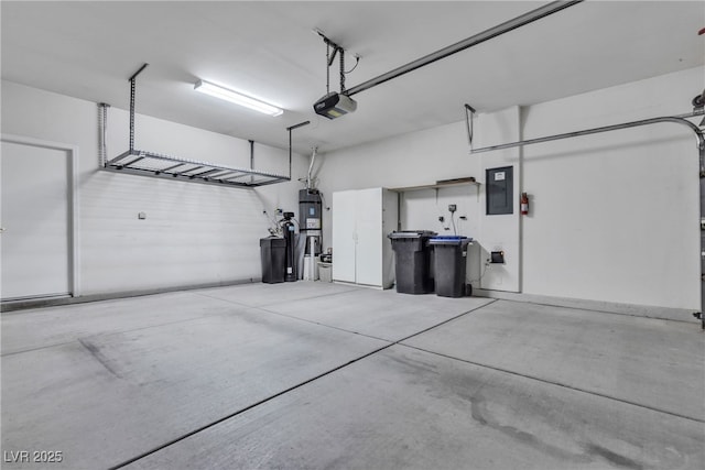 garage featuring electric panel, a garage door opener, and water heater