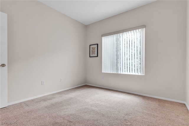 carpeted empty room with baseboards