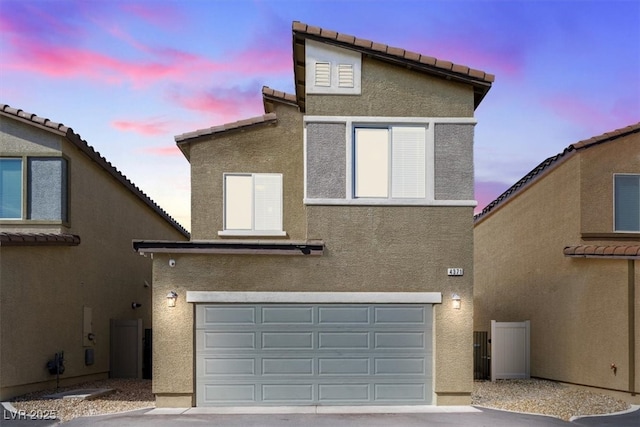 view of front of property with a garage and stucco siding