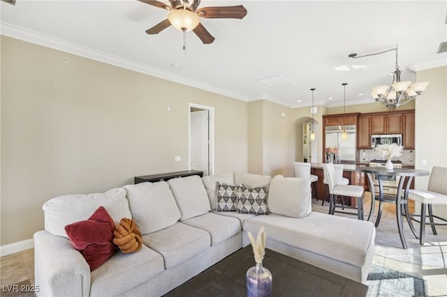 living room featuring visible vents, arched walkways, baseboards, ornamental molding, and ceiling fan with notable chandelier