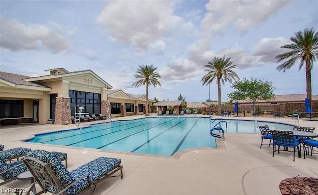 pool featuring fence and a patio