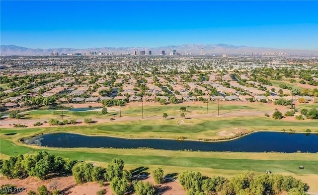 birds eye view of property with view of golf course and a water and mountain view