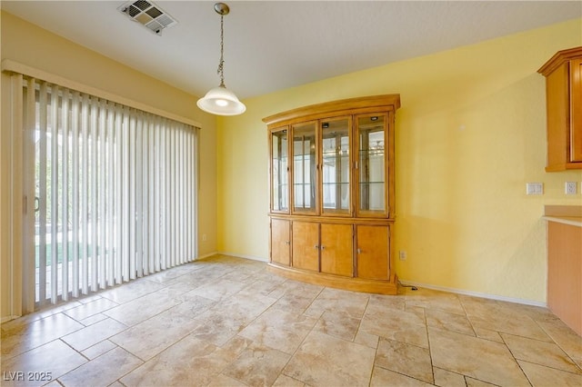 unfurnished dining area featuring visible vents and baseboards