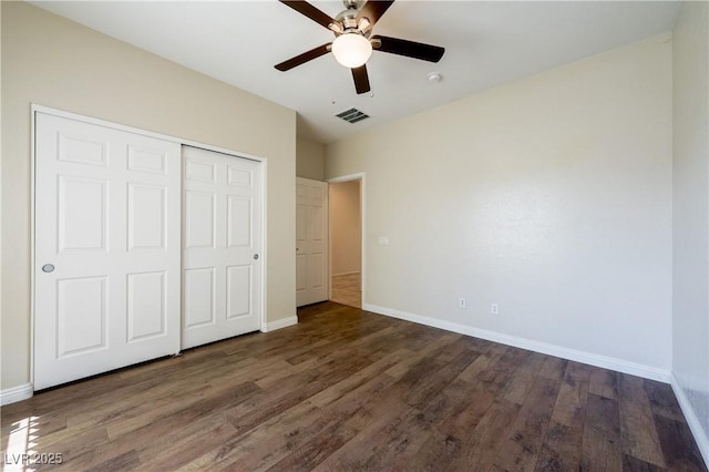 unfurnished bedroom featuring dark wood-style floors, baseboards, and visible vents