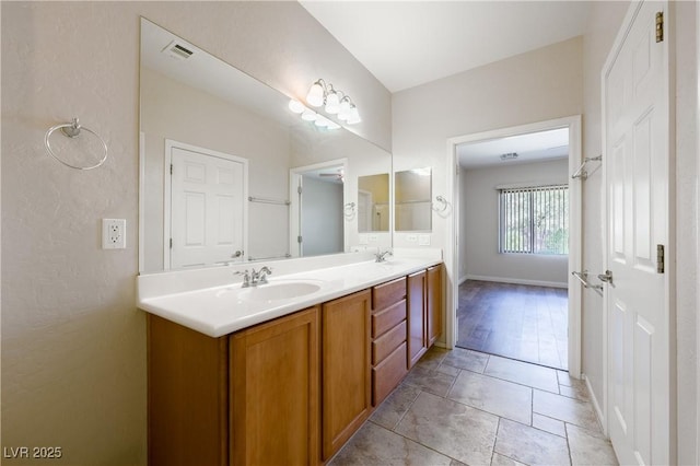 full bathroom with visible vents, a sink, baseboards, and double vanity