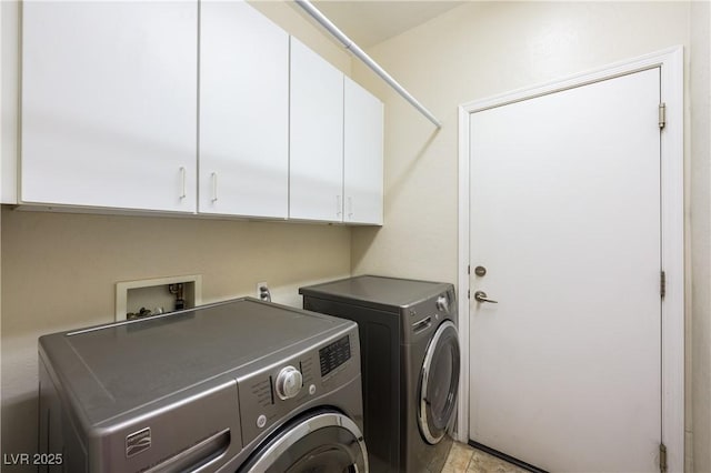 laundry area featuring washing machine and dryer and cabinet space