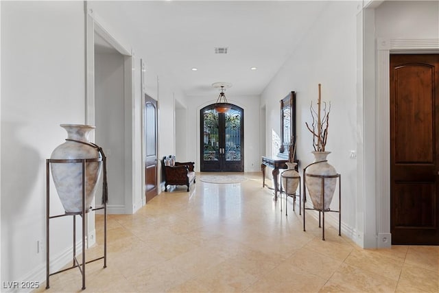 foyer with recessed lighting, visible vents, baseboards, and french doors