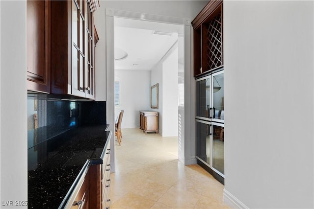 kitchen featuring baseboards and decorative backsplash