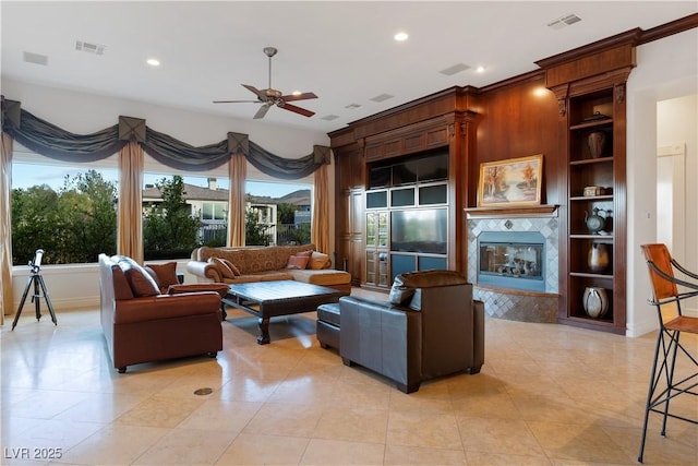 living room featuring built in shelves, visible vents, a fireplace, and recessed lighting