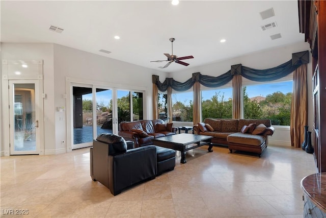 living area featuring recessed lighting, visible vents, and a healthy amount of sunlight