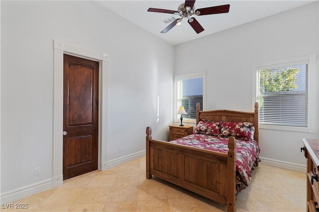 bedroom featuring light tile patterned floors, ceiling fan, and baseboards