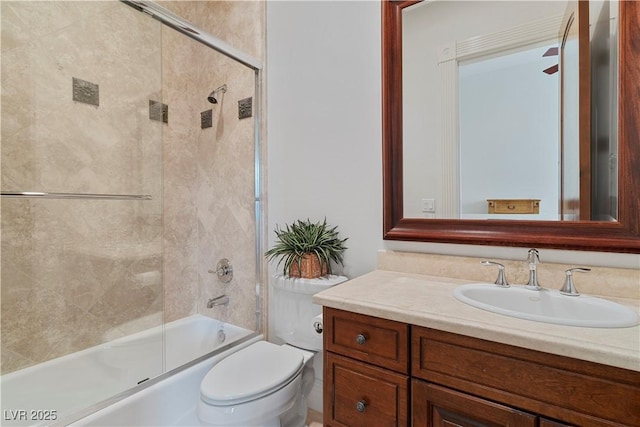 full bath featuring toilet, shower / bath combination with glass door, and vanity