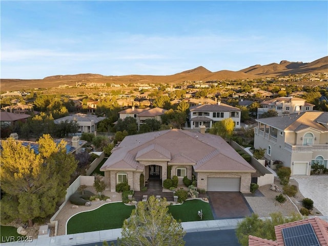 birds eye view of property with a mountain view and a residential view