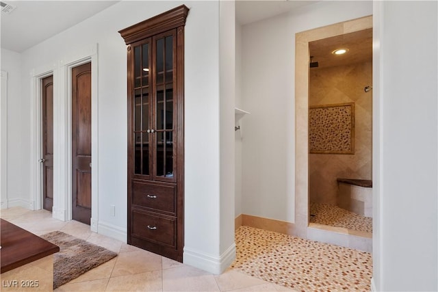 full bath featuring a walk in shower, tile patterned flooring, visible vents, and baseboards