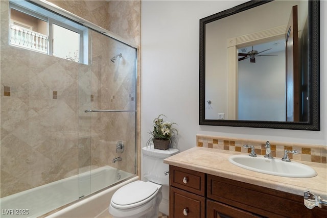 bathroom with toilet, tasteful backsplash, bath / shower combo with glass door, and vanity