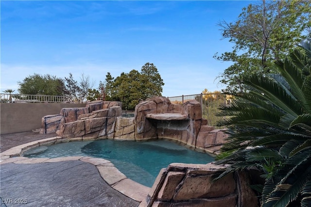 view of swimming pool featuring a fenced in pool and fence