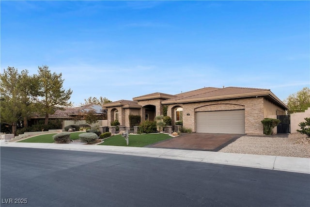 mediterranean / spanish-style home with driveway and an attached garage