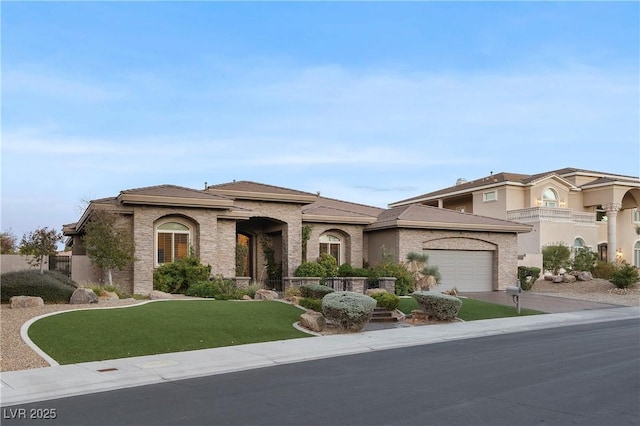 view of front of property featuring driveway, a front lawn, and an attached garage