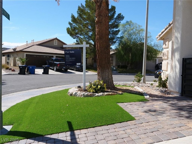 view of yard with driveway and an attached garage