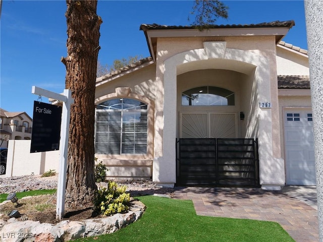 view of front of home with a tile roof and stucco siding