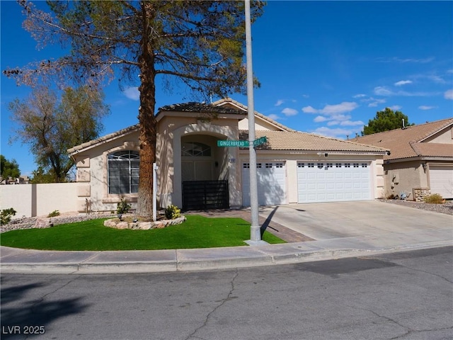 view of front of home with stucco siding, an attached garage, fence, driveway, and a tiled roof