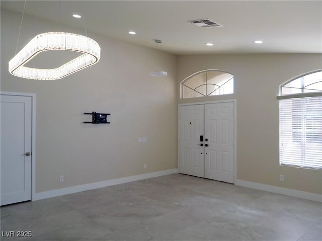 foyer featuring a healthy amount of sunlight, baseboards, and visible vents