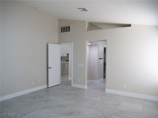 unfurnished bedroom with high vaulted ceiling, baseboards, a spacious closet, and visible vents