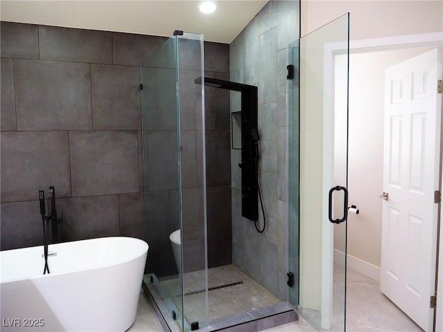 bathroom with a soaking tub, a shower stall, tile walls, and recessed lighting