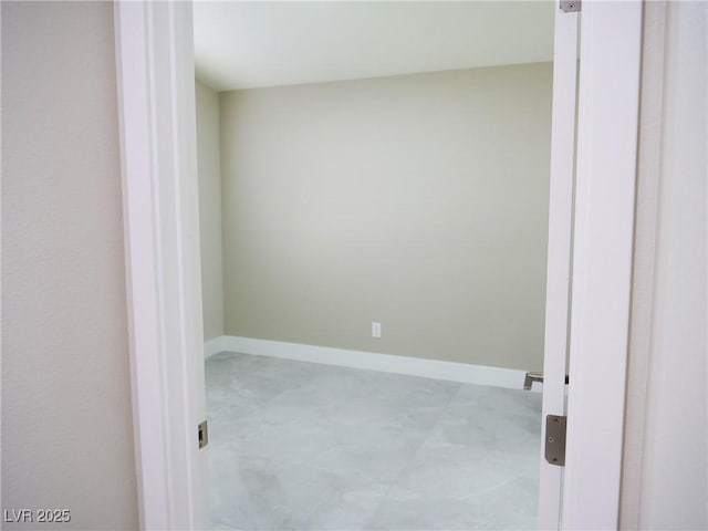 spare room featuring baseboards