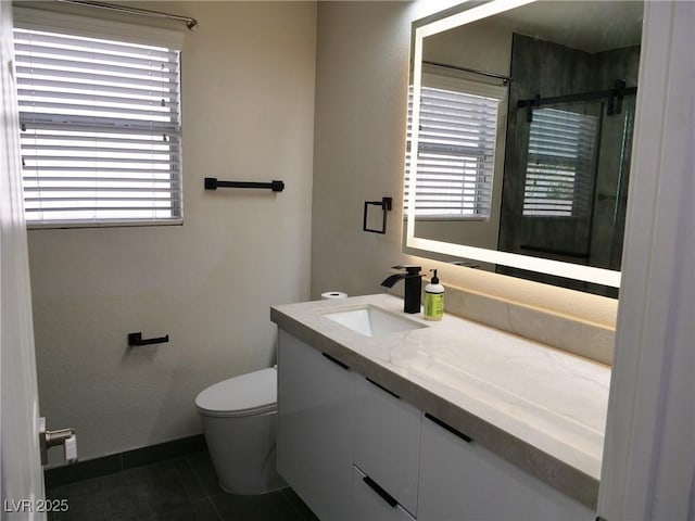 bathroom featuring toilet, tile patterned floors, a shower stall, and vanity